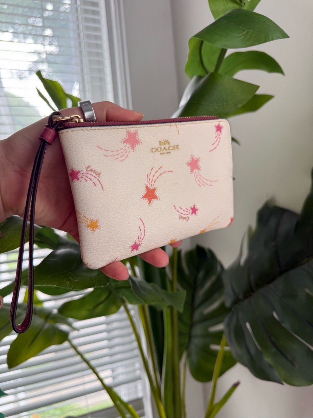 COACH Cream Wristlet with Pink and Orange Shooting Stars